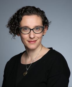 Image of Alexis Lothian: a white woman in her late 30s with glasses and short, dark curly hair